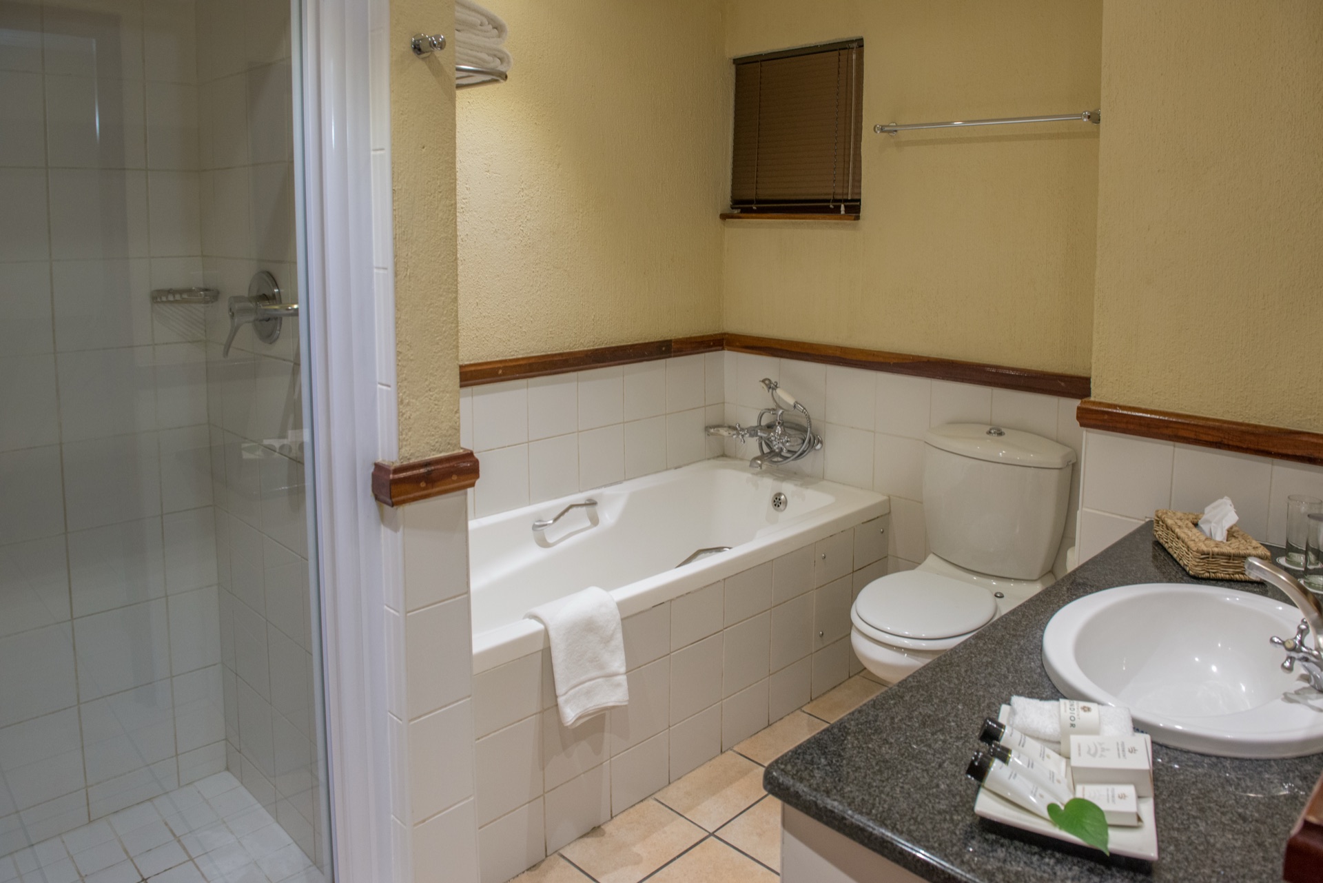 Bathroom with tub, shower and vanity at Mondior Gaborone