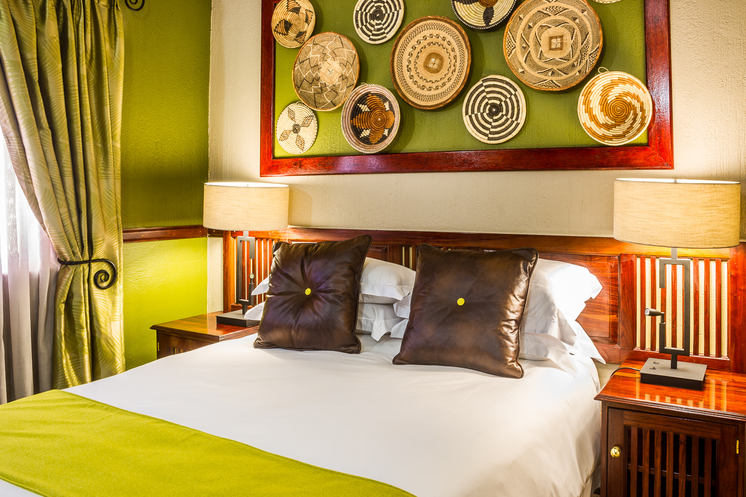 Executive Suite bed with woven basket wall art at Mondior Gaborone