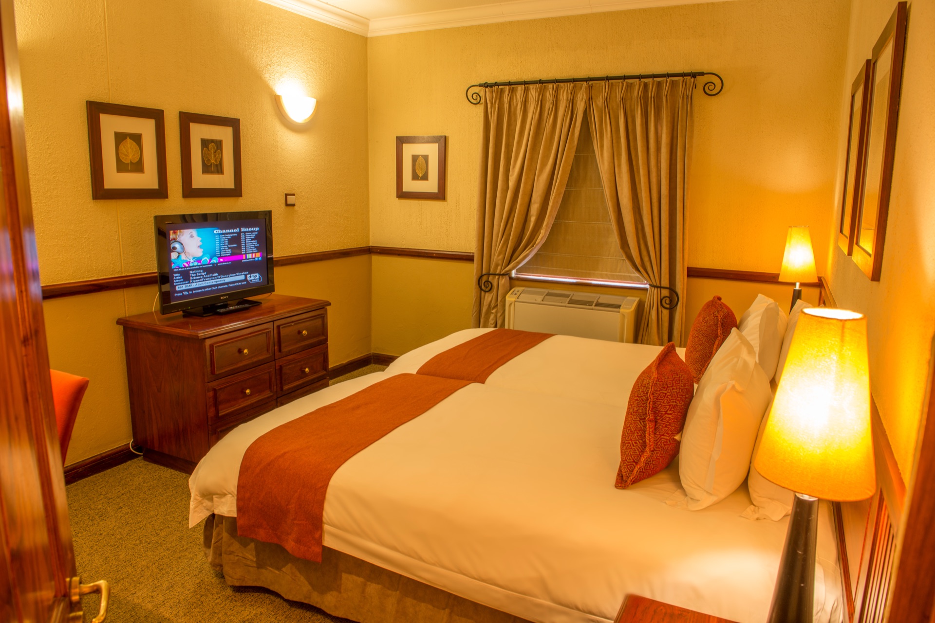 Executive Suite double bed and dresser at Mondior Gaborone