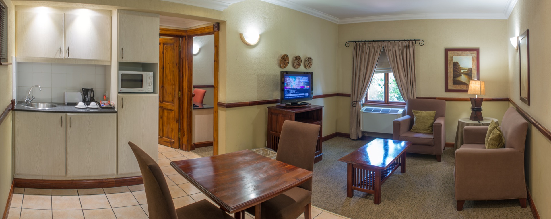 Executive Suite lounge and kitchenette at Mondior, a 4-star hotel in Gaborone