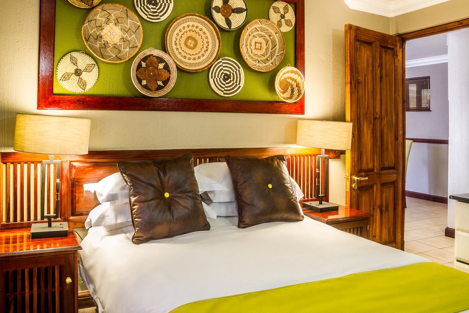 Guest room with African basket wall art at Mondior Gaborone